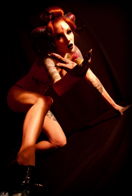 Goth model Razor Candi extends her tongue during a solo shoot 76817655
