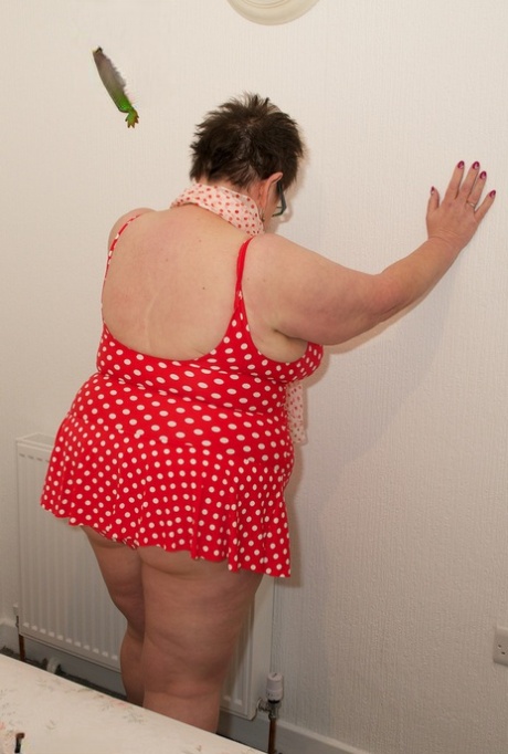 Obese amateur takes off a polka-dot dress to get naked in socks and footwear 31945023