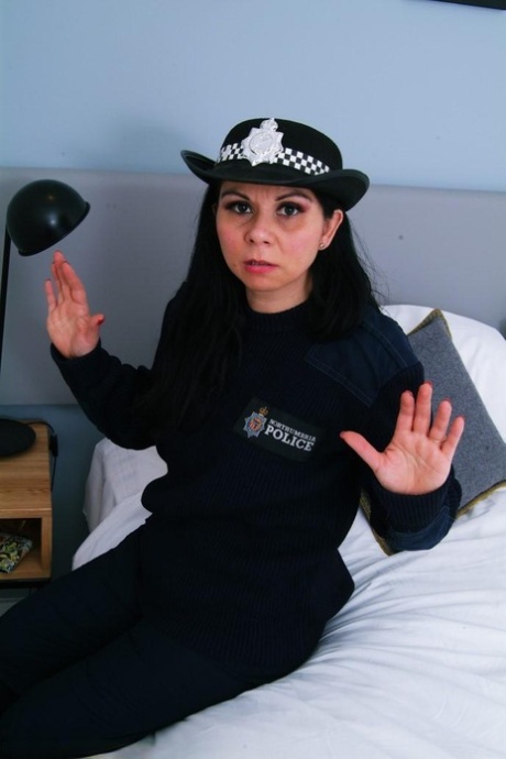 Dark-haired police woman finds herself taped to a chair in her uniform 85562207