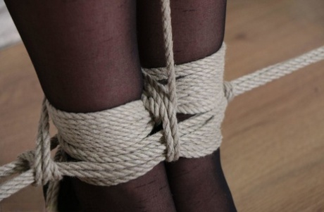Fully clothed girl in black pantyhose tied with ropes, blindfolded & gagged 53352259
