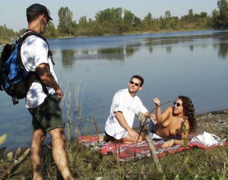 Horny couple partakes in MMF sex with a hiker near the water 54391662