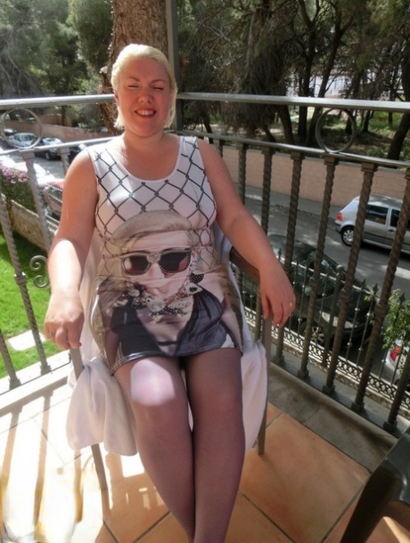 Older plumper Barby gets naked on her balcony as cars pass by below