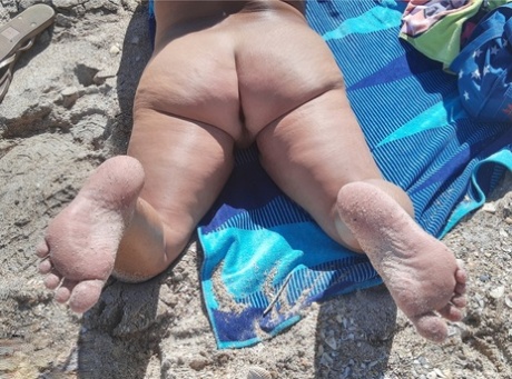 Older amateur Debbie Delicious sunbathes in shades on a nude beach 76045365